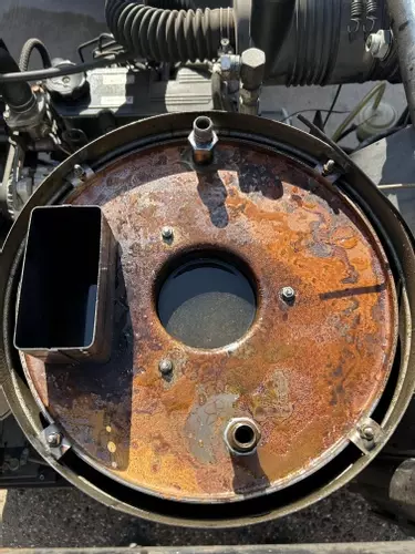 Open boiler on Nilfisk Contractor diesel pressure washer showing water inside jacket after coil failure.